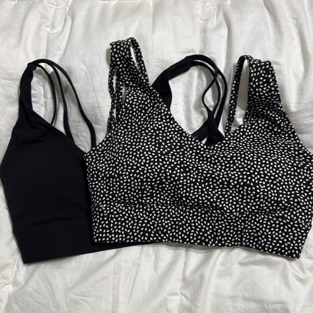 Solid black sports bra and polka dot sports bra